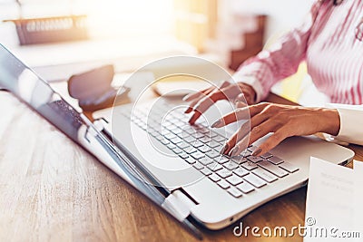 Women hands typing on the keyboard Work at home. Stock Photo