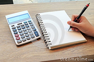 Women hands writing with pencil, notebook and Calculator Stock Photo