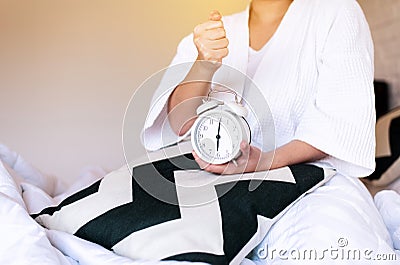 Women hates getting stressed waking up late 6 o`clock,Alarm clock,Weekend morning Stock Photo