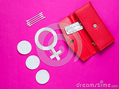 Women Health. Products for feminine hygiene, self-care, female gender symbol on pink background. Ear sticks, pads, pills in purse Stock Photo