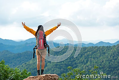 Women hiker or traveler with backpack adventure feeling victorious facing on the mountain, outdoor for education nature on vacatio Stock Photo