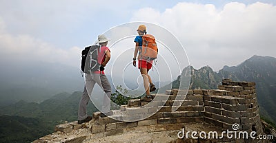 women hikers enjoy the view on the top of great wall Stock Photo