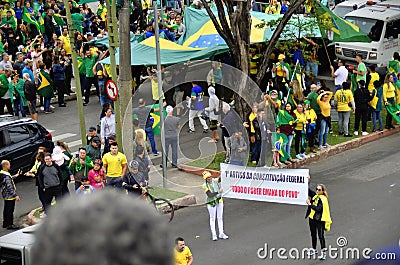 Women hold the banner written: 1st article of the federal constitution: `All power emanates from the people` in the midst of the c Editorial Stock Photo