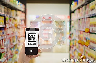 Women hold smartphones in hand,scanning store QR code to check prices,receive promotions and discount in supermarket,cashless Stock Photo