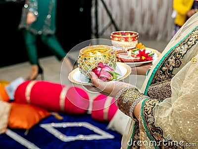 Women holding candles for mendhi henna wedding Stock Photo