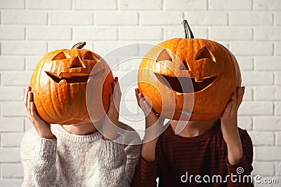 Women holding Halloween pumpkin head jack lanterns Stock Photo