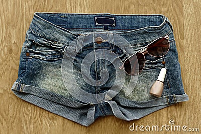 Women jeans shorts, nail polish and sunglasses Stock Photo
