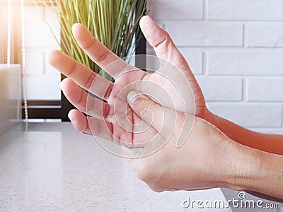 Close-up of women hand with massage hands, fingers and palm from pain and numbness, Exercise and massage to relieve hand pain Stock Photo
