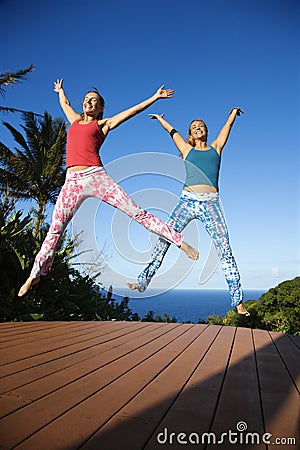 Women jumping into air. Stock Photo