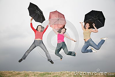 Women jumping with umbre Stock Photo