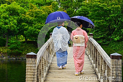 Women in kimono walking on wooden bridge Editorial Stock Photo