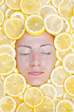 Women with lemons on face Stock Photo