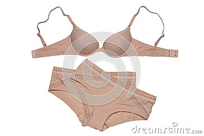Women lingerie isolated. Close-up of beige or flesh-colored bra and two panties isolated on a white background. Useful for wearing Stock Photo