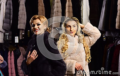 Women with makeup shopping in fashion fur store. Stock Photo