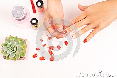 Women manicure and attaches a nail shape during the procedure of nail extensions with gel at home. Fashion and Beauty concept Stock Photo