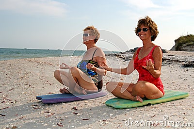 Women meditation on beach Stock Photo
