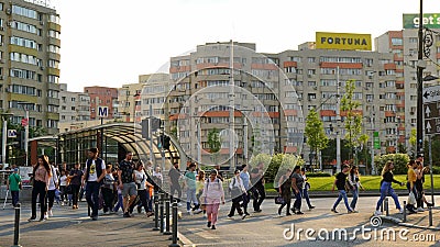 People crossing the street, coming from metro or tram stop, at Obor station at rush hour in Bucharest, Romania on May 16, 2022 Editorial Stock Photo