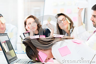 Women and men in office being tired and frustrated Stock Photo