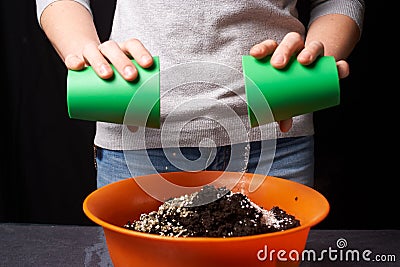 Women mixing ground with minerals in container for plant Stock Photo