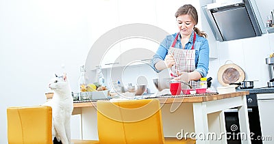 Women are mixing the ingredients of a cake in a stainless bowl i Stock Photo