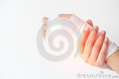 Women with painful wrist due to overuse or sport accidental on white background, Hand of girl strapping with bandage and Cure Stock Photo