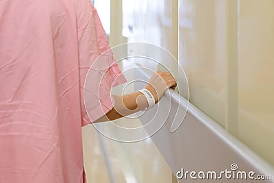 Women patient hand holding to handrail in hospital Stock Photo