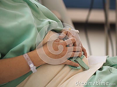 Women Patients admitted to the hospital admit treatment to cure patient Ward stomachache sitting bed Stock Photo