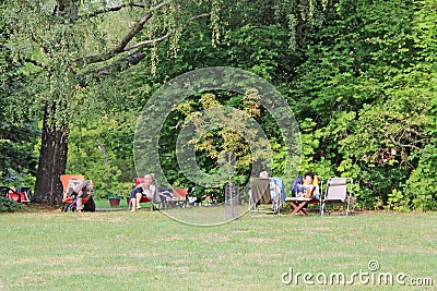 Women pensioners rest in city park. Elderly women enjoy vacation in country Editorial Stock Photo