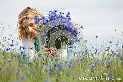 Women picking blue flowers Stock Photo