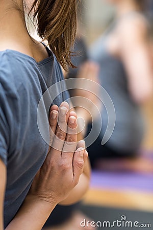 Women practicing yoga: reverse prayer pose Stock Photo