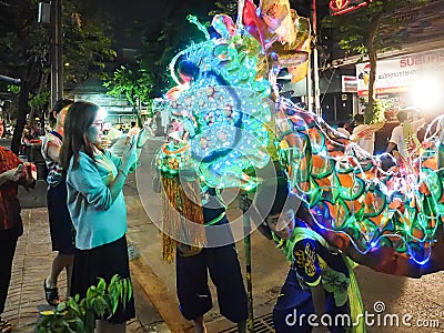 Women put a money in dragon mouth in vegetarian festival Editorial Stock Photo