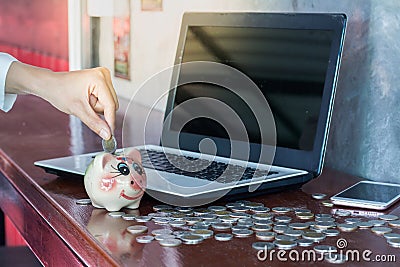 Women putting coin in piggy bank. saving money, Stock Photo