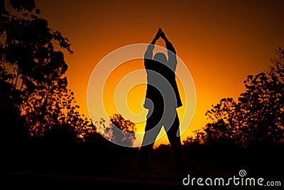 Women relaxing and exercising on moning of sihouette sky background Stock Photo