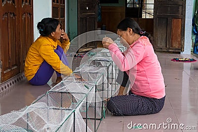 Women repairing fishing nets near Da Nang Editorial Stock Photo