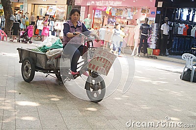 Women riding a tricycle Editorial Stock Photo