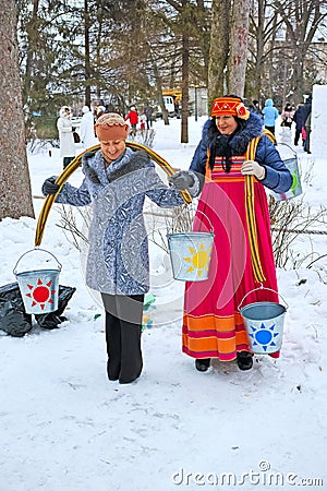 Women with rockers carrying buckets of water Editorial Stock Photo