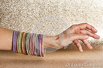 Women`s arm with multiple multi-colored bracelets Stock Photo