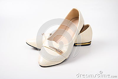 women`s beige ballet flats on a white background. Stock Photo
