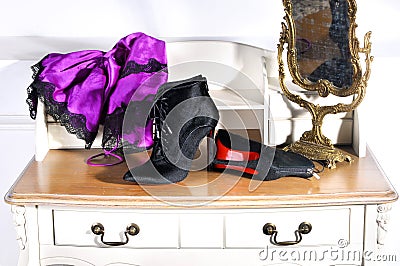 Women`s black ankle boots handmade. showing red soles. female boudoir dressing table and mirror Editorial Stock Photo