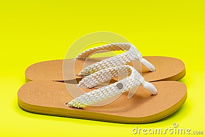 Women`s Causal Braided natural color Beach Day Flip Flops isolated on bright yellow Stock Photo