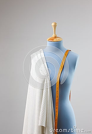 Women`s clothing dummy with measuring tape in tailors studio Stock Photo