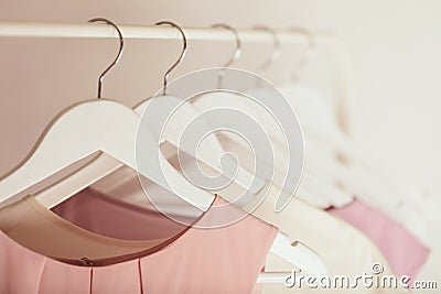 Women`s clothing in pink tones on a white hanger. Stock Photo