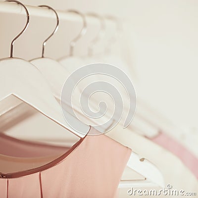 Women`s clothing in pink tones on a white hanger. Stock Photo