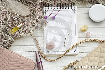 Women`s flatlay with notebook, handbag, cosmetics, cristall and minerals. Stock Photo