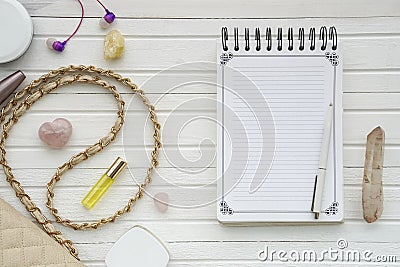 Women`s flatlay with notebook, handbag, cosmetics, cristall and minerals. Stock Photo