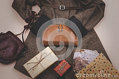 Women`s grey coat and many other women`s accessories around. Lifestyle Stock Photo