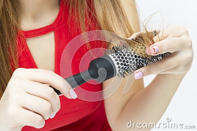 Women`s Hairloss Issues. Closeup iof Hands of Caucasian Female With Hair Problems. Checking Hair in Hairbrush. Stock Photo