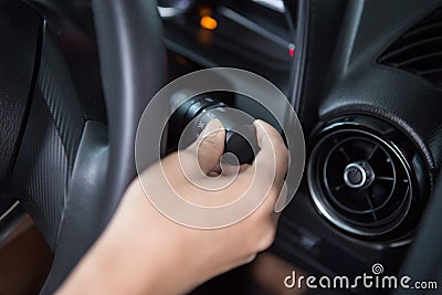 Women`s hand is adjusting headlights Stock Photo