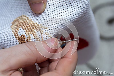 Women& x27;s hand embroidery in a hoop, a woman embroider a pattern on dark material. Close-up. The concept of needlework, hobby, Stock Photo