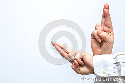 Female hands in a gesture of `fingers crossed` meaning success, faith,hope,happiness in achiving the goal. Place for text Stock Photo